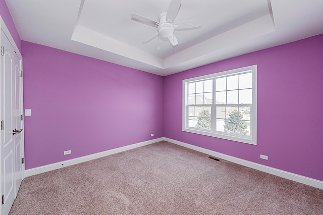 Photo of a mid-sized transitional kids' bedroom for kids 4-10 years old and girls in Chicago with pink walls, carpet and grey floor.