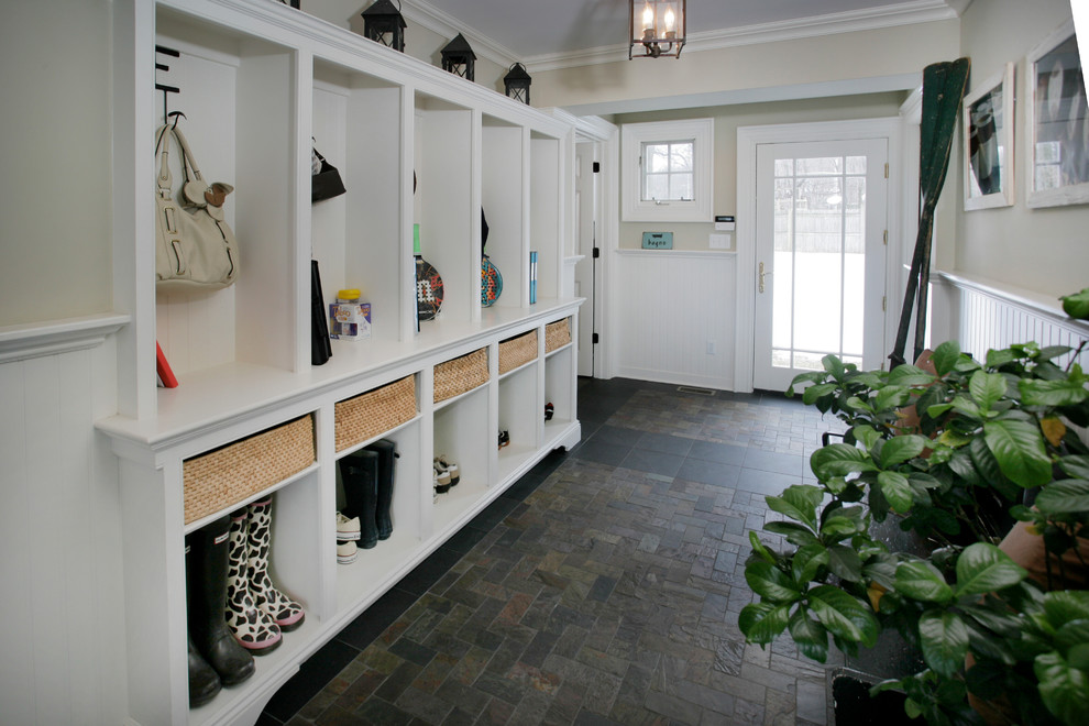 Photo of a traditional mudroom in New York with slate floors.