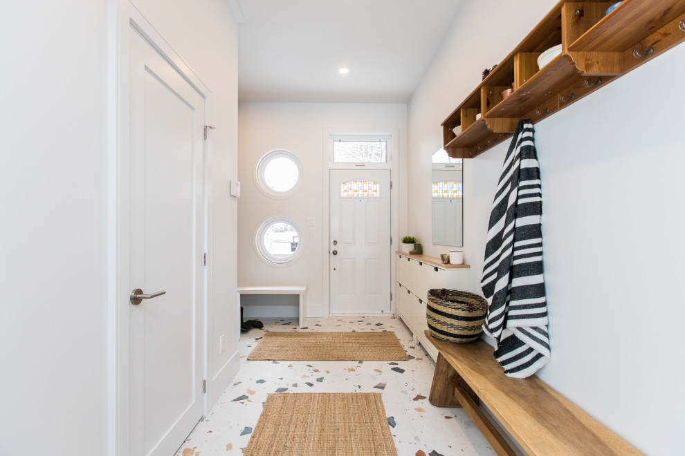 Photo of a large beach style foyer in Ottawa with white walls, porcelain floors, a single front door, a white front door and multi-coloured floor.