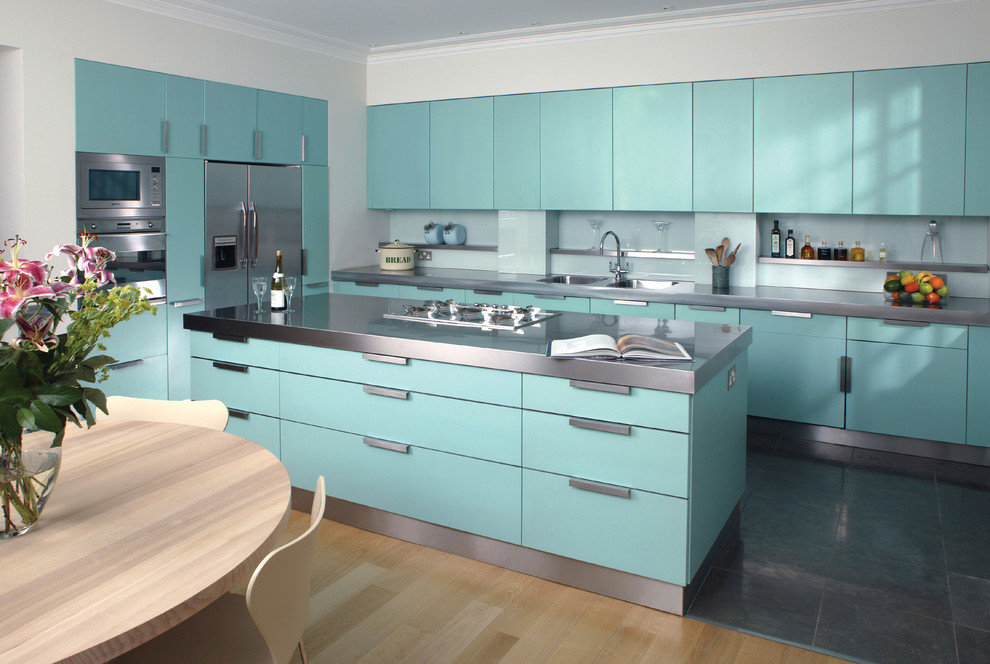 Design ideas for an industrial kitchen in Hertfordshire with stainless steel benchtops and stainless steel appliances.