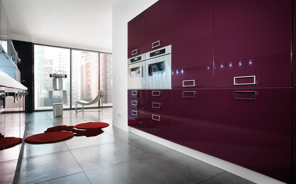 Photo of a large modern galley kitchen in Miami with flat-panel cabinets, purple cabinets, stainless steel appliances and grey floor.