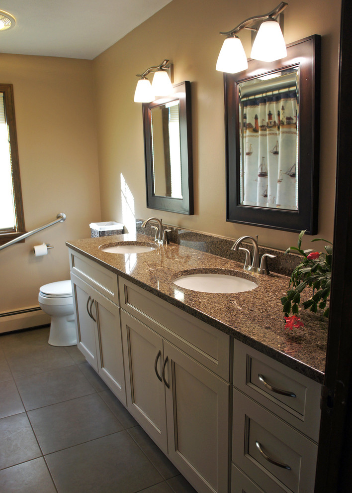 This is an example of a mid-sized transitional kids bathroom in Bridgeport with recessed-panel cabinets, white cabinets, an alcove shower, a two-piece toilet, beige tile, beige walls, ceramic floors, an undermount sink, engineered quartz benchtops, brown floor and a shower curtain.