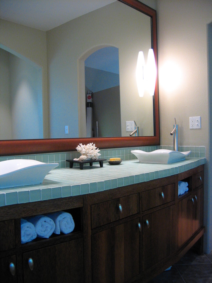 This is an example of an asian bathroom in San Francisco with turquoise benchtops.