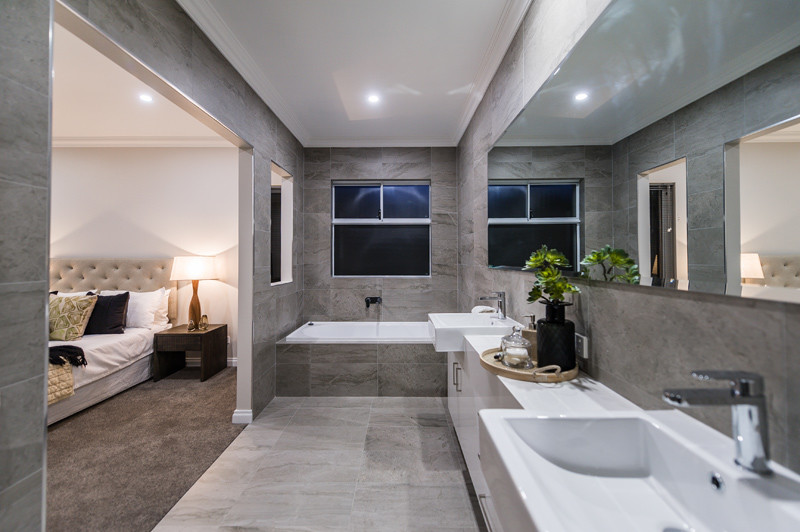 Inspiration for a contemporary master bathroom in Perth with white cabinets, a drop-in tub, an open shower, a wall-mount toilet, gray tile, ceramic tile, grey walls, ceramic floors and quartzite benchtops.