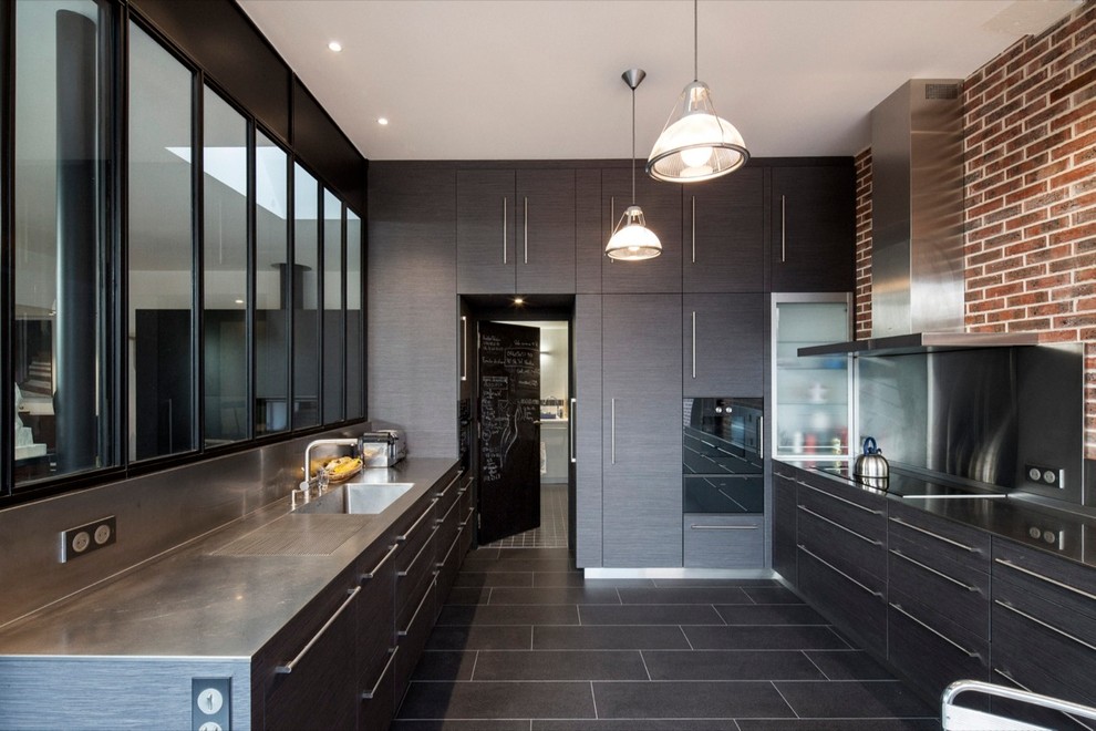 Inspiration for a large contemporary u-shaped separate kitchen in Paris with an integrated sink, flat-panel cabinets, dark wood cabinets, stainless steel benchtops, metallic splashback, no island, metal splashback, panelled appliances and ceramic floors.