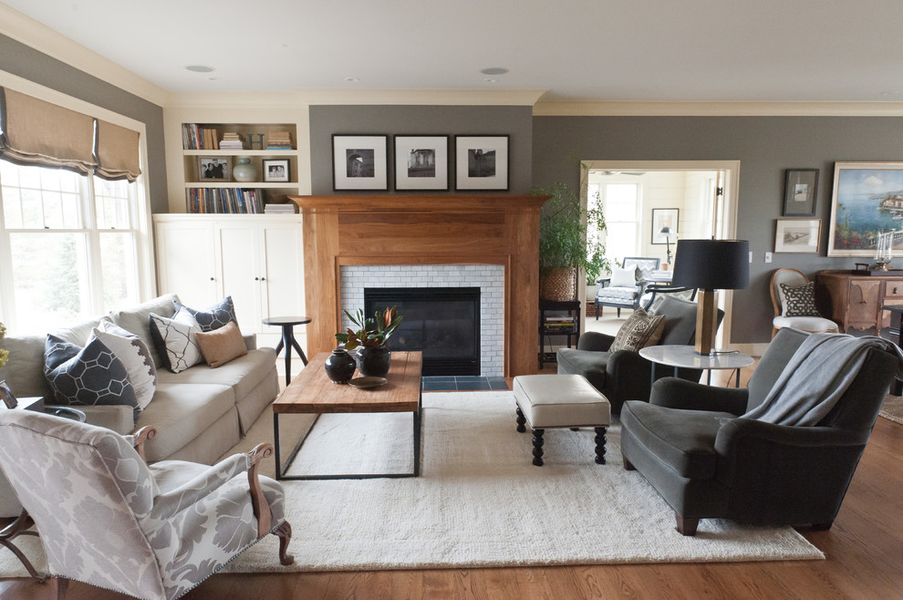 Inspiration for a beach style living room in Minneapolis with grey walls, a tile fireplace surround and brown floor.