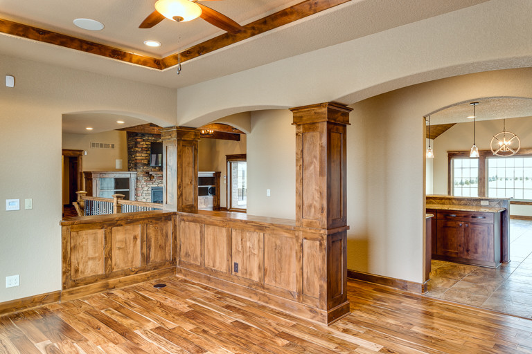 Inspiration for a large rustic medium tone wood floor great room remodel with beige walls