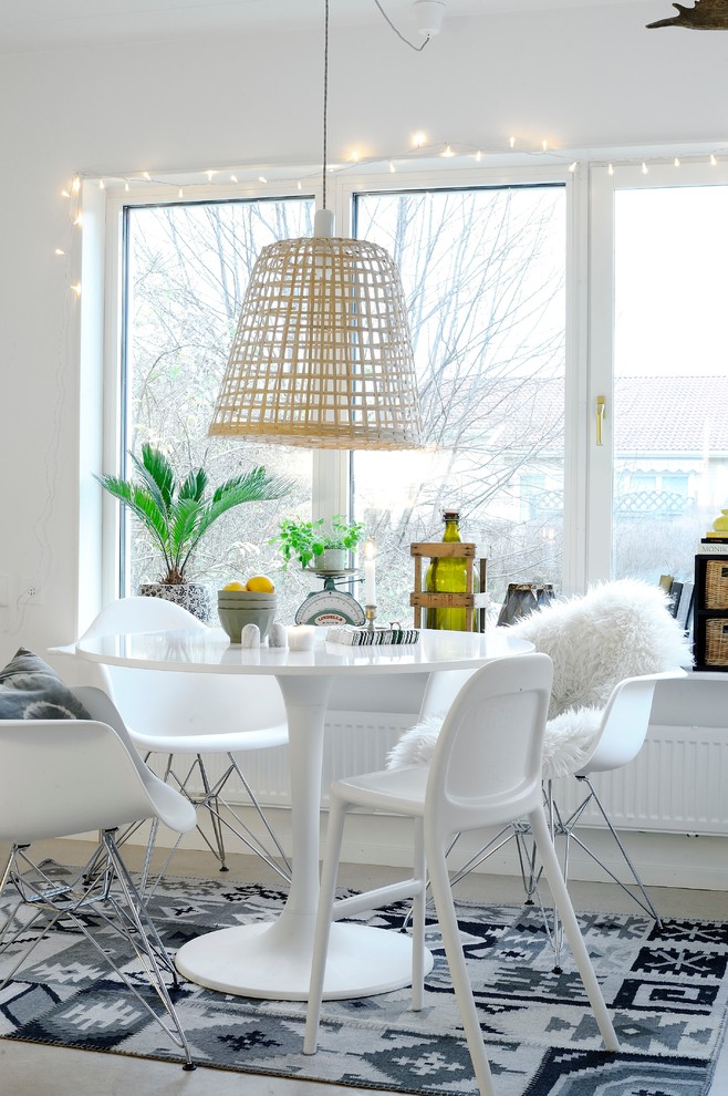 This is an example of an eclectic dining room in Orebro with white walls and no fireplace.