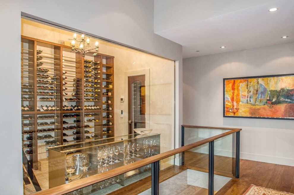 Small modern wine cellar in Denver with limestone floors and display racks.