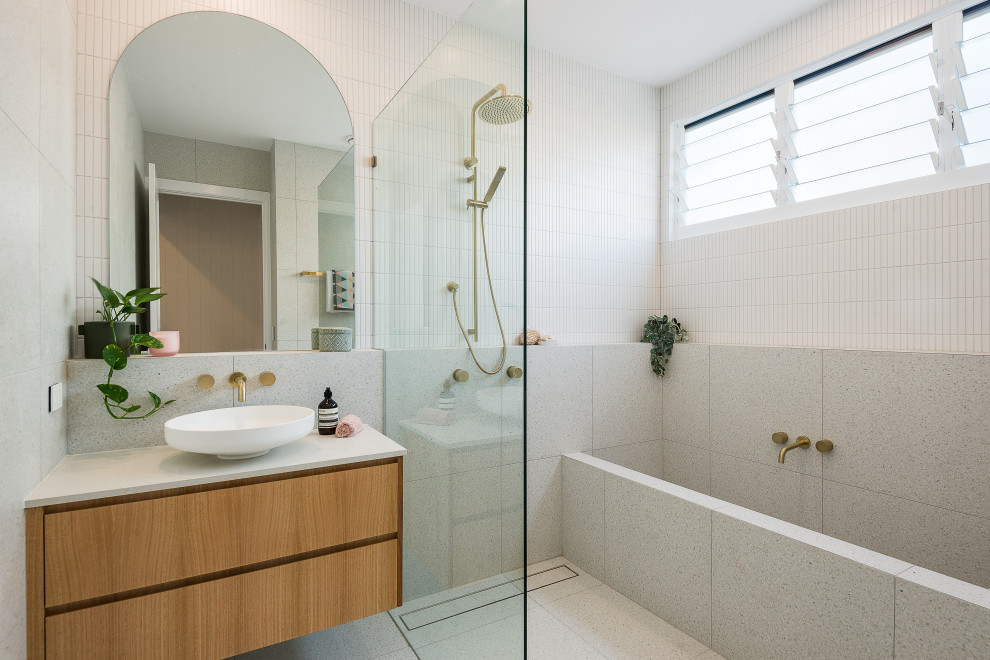Photo of a mid-sized contemporary bathroom in Brisbane with white tile, terrazzo floors, an open shower, a double vanity and a floating vanity.