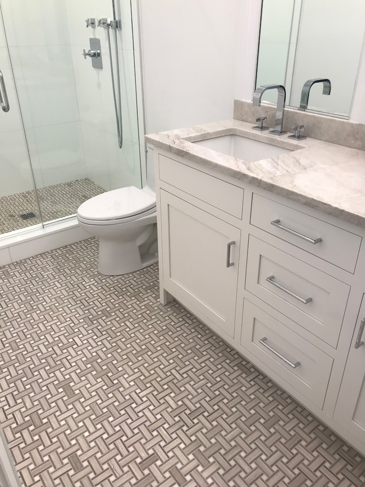 This is an example of a large contemporary kids bathroom in New York with white walls, marble floors, marble benchtops, brown floor, a hinged shower door and brown benchtops.