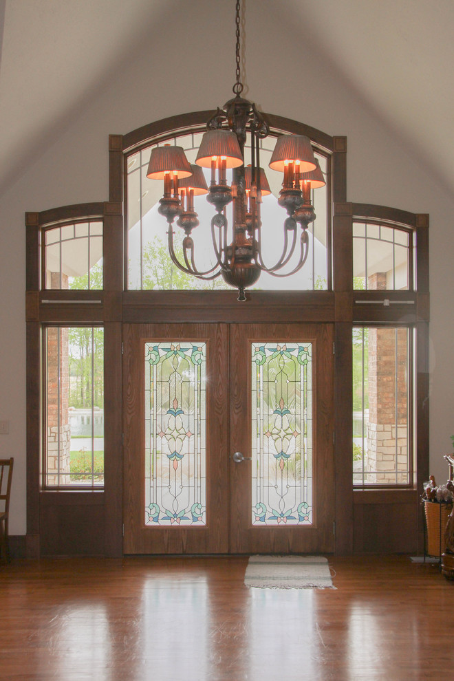 Inspiration for a huge rustic dark wood floor and brown floor front door remodel with white walls and a medium wood front door