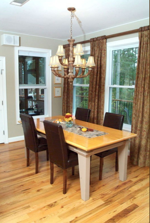 Inspiration for a mid-sized transitional light wood floor dining room remodel with beige walls