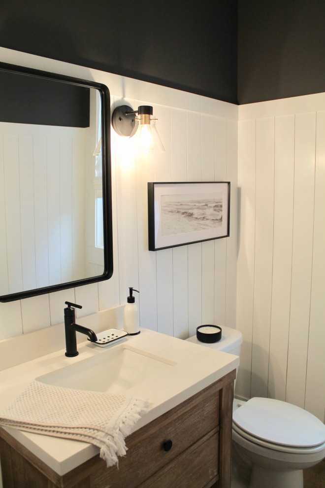 Large country light wood floor, single-sink and shiplap wall bathroom photo in Raleigh with furniture-like cabinets, light wood cabinets, a one-piece toilet, black walls, an undermount sink, quartzite countertops, white countertops and a freestanding vanity