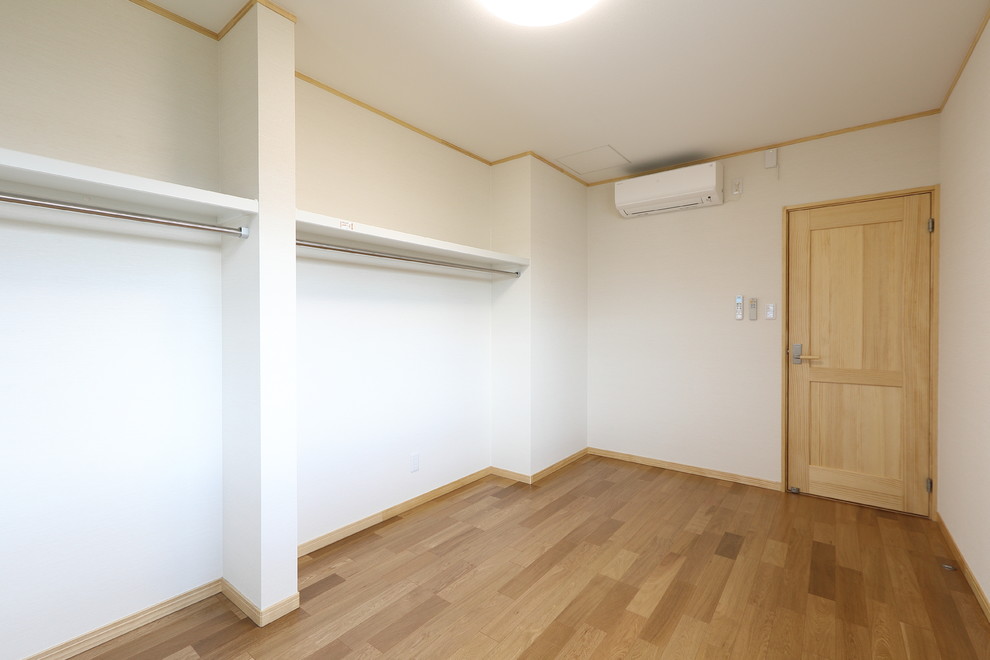 Design ideas for a large storage and wardrobe in Other with plywood floors and beige floor.