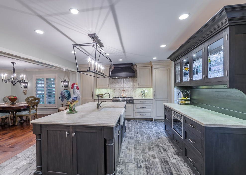Design ideas for a mid-sized traditional galley eat-in kitchen in Chicago with grey cabinets, marble benchtops, white splashback, ceramic splashback, stainless steel appliances, painted wood floors, with island, multi-coloured floor, an undermount sink, raised-panel cabinets, grey benchtop and exposed beam.