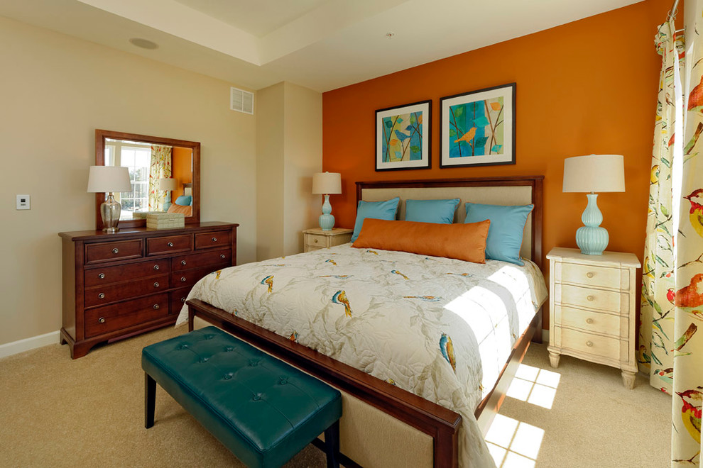 Design ideas for a mid-sized traditional master bedroom in Baltimore with orange walls and carpet.