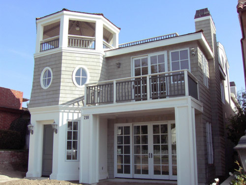 This is an example of a small traditional two-storey grey exterior in New York with wood siding.