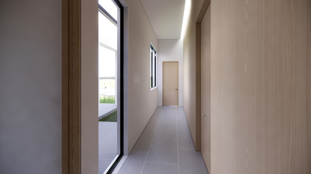 Modelo de recibidores y pasillos contemporáneos con paredes blancas, suelo de piedra caliza, suelo gris, panelado y iluminación