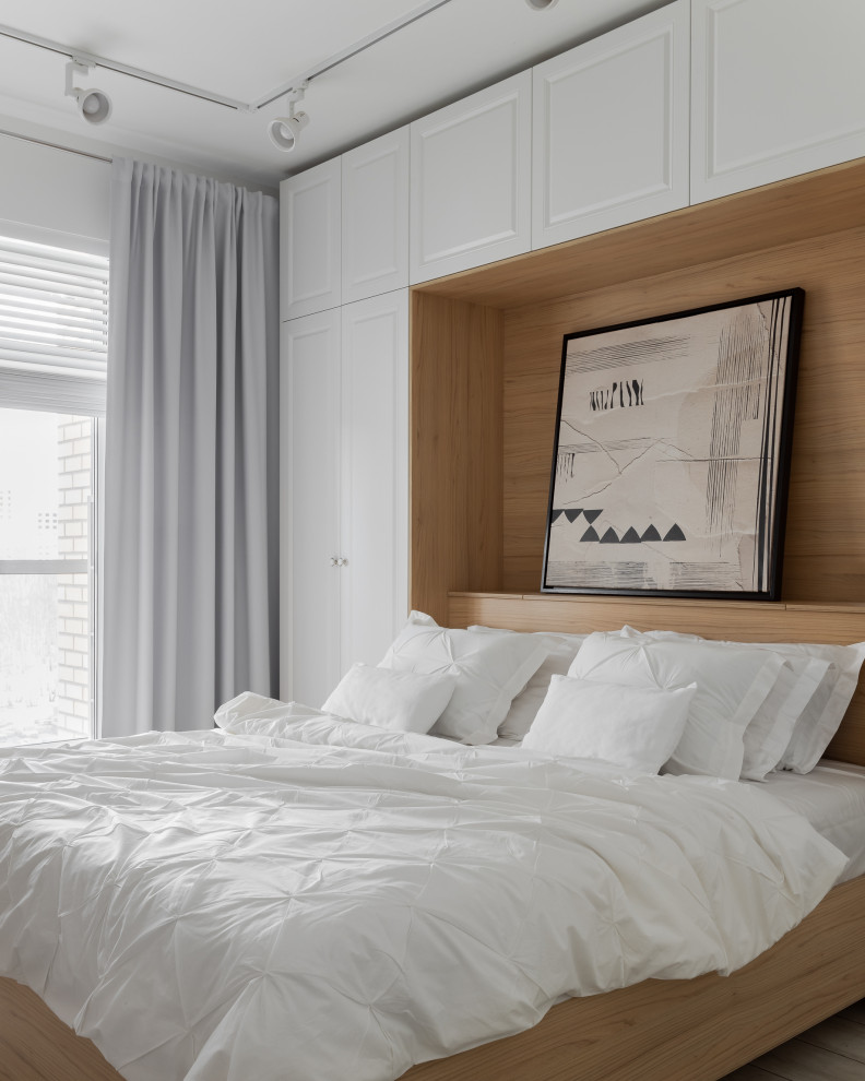 Foto de dormitorio principal y blanco y madera nórdico de tamaño medio con paredes blancas, suelo vinílico y suelo gris