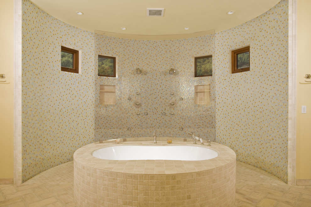 This is an example of a mediterranean bathroom in San Francisco with a curbless shower, a freestanding tub and mosaic tile.