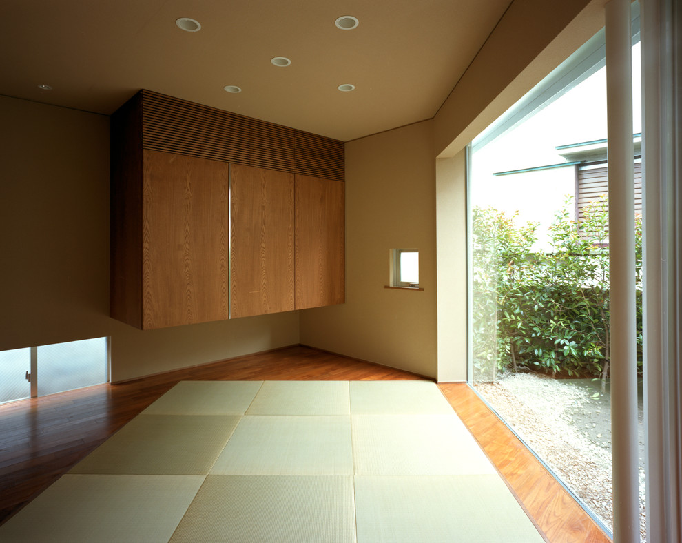 Imagen de habitación de invitados asiática de tamaño medio sin chimenea con paredes beige, tatami y suelo beige