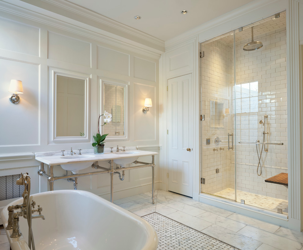 Design ideas for a traditional master bathroom in DC Metro with a freestanding tub, white tile, ceramic tile, white walls, marble floors, marble benchtops and a console sink.