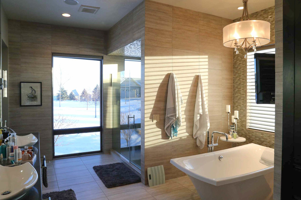 Large transitional master beige tile and porcelain tile porcelain tile and beige floor freestanding bathtub photo with shaker cabinets, black cabinets, a two-piece toilet, beige walls, a vessel sink, quartzite countertops, a hinged shower door and black countertops