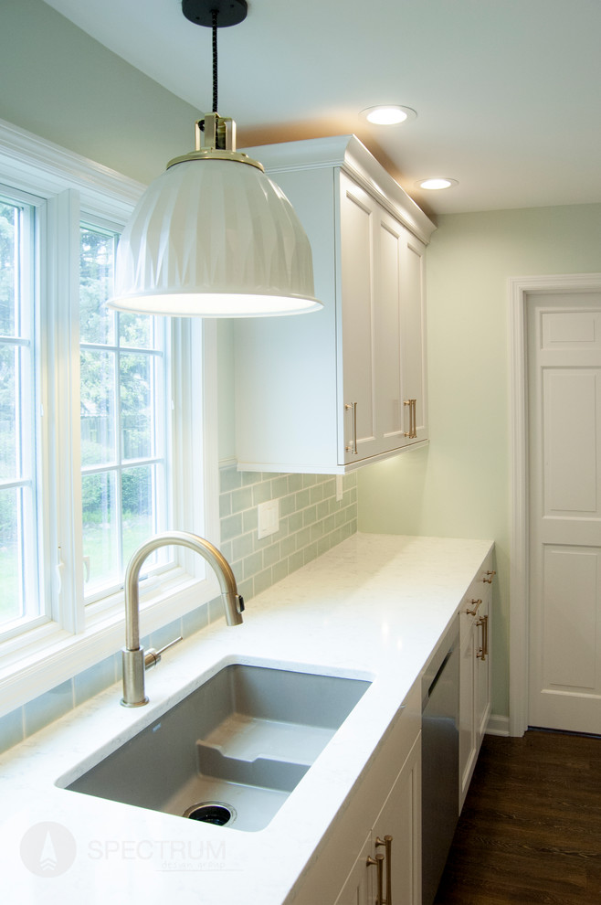 Eat-in kitchen - mid-sized transitional l-shaped dark wood floor eat-in kitchen idea in Chicago with a double-bowl sink, raised-panel cabinets, white cabinets, granite countertops, green backsplash, ceramic backsplash, stainless steel appliances and an island