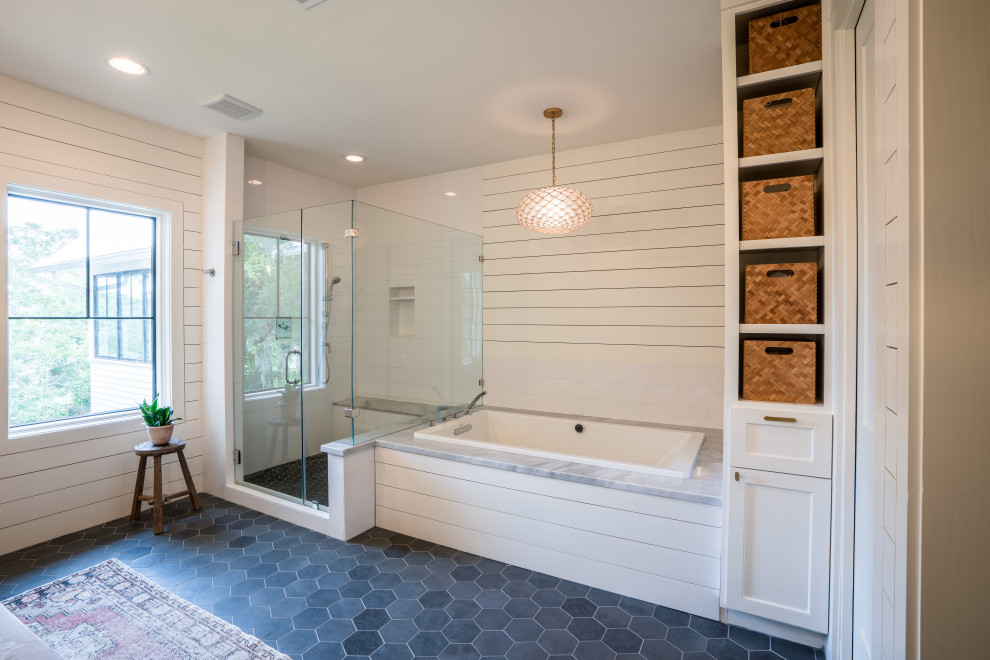 Design ideas for a large transitional master bathroom in Houston with white tile, subway tile, white walls, porcelain floors, grey floor, a hinged shower door, planked wall panelling, a drop-in tub and a corner shower.