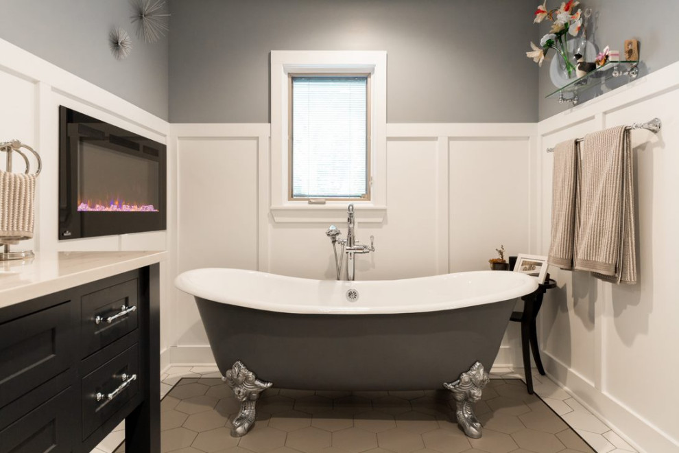 Photo of a medium sized modern ensuite bathroom in Grand Rapids with a freestanding bath and quartz worktops.