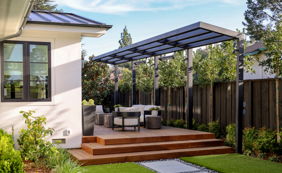 Contemporary backyard and ground level deck in San Francisco with a fire feature and a pergola.