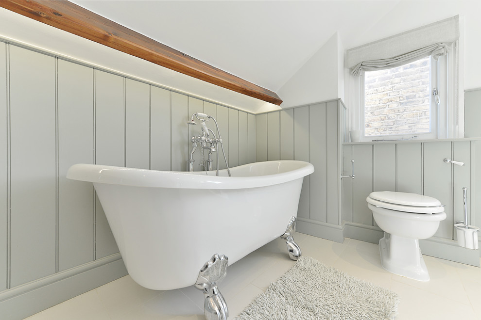 Inspiration for a mid-sized traditional kids bathroom in London with a freestanding tub, a corner shower, a one-piece toilet, beige tile, porcelain tile, multi-coloured walls, porcelain floors, a pedestal sink, flat-panel cabinets, dark wood cabinets, wood benchtops, white floor and an open shower.