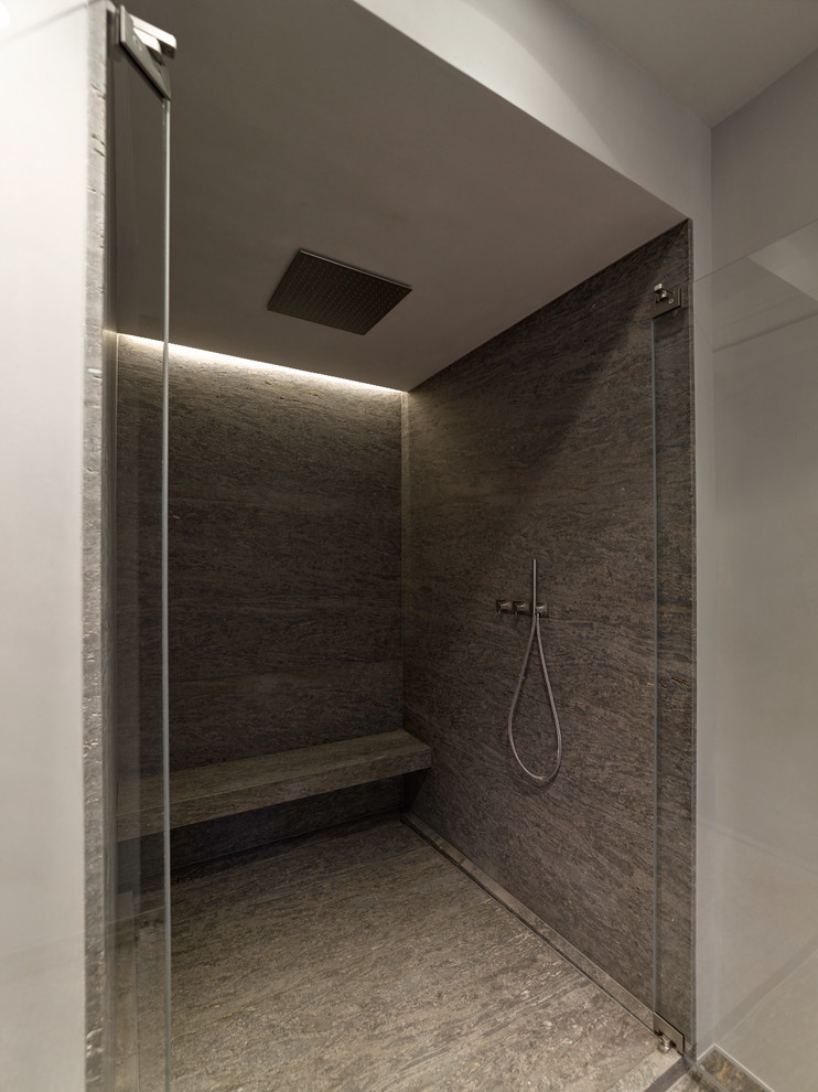 Badezimmer En Suite With flächenbündigen Schrankfronten, weißen Schränken, freistehender Badewanne, bodengleicher Dusche, Wandtoilette, beigen Fliesen, beiger Wandfarbe, Vinylboden, Aufsatzwaschbecken, Granit-Waschbecken/Waschtisch, braunem Boden and Falttür-Duschabtrennung in Stuttgart