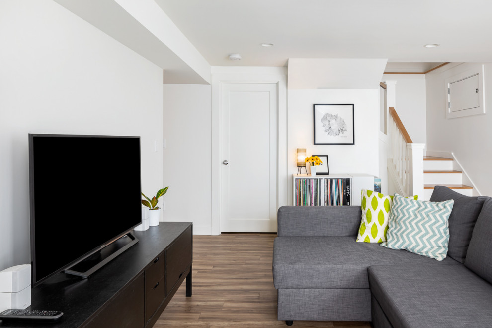 Inspiration for a mid-sized modern walk-out basement in Seattle with white walls, vinyl floors and brown floor.