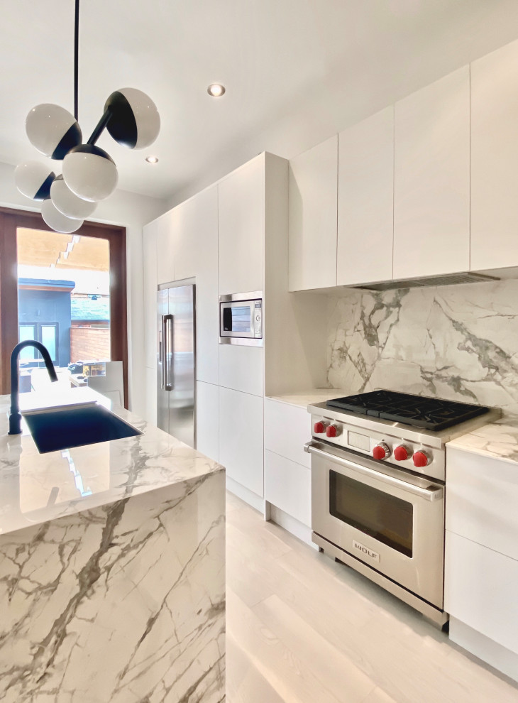 Example of a mid-sized minimalist single-wall light wood floor enclosed kitchen design in Toronto with flat-panel cabinets, white cabinets, an island, quartz countertops, white backsplash, quartz backsplash, stainless steel appliances and white countertops