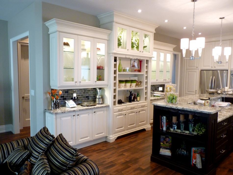 Inspiration for a large transitional u-shaped dark wood floor eat-in kitchen remodel in Toronto with an undermount sink, raised-panel cabinets, white cabinets, granite countertops, metallic backsplash, ceramic backsplash, stainless steel appliances and an island