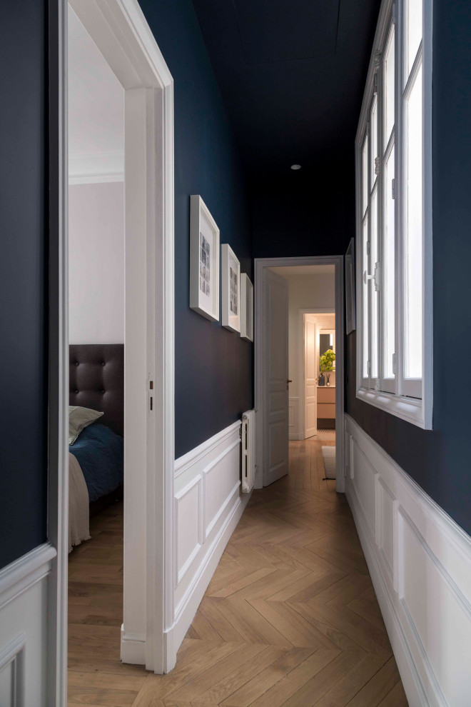 Inspiration for a large transitional hallway in Paris with black walls, light hardwood floors and beige floor.