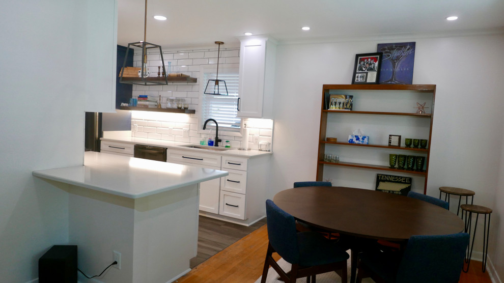 Mid-sized transitional galley porcelain tile and gray floor eat-in kitchen photo with an undermount sink, shaker cabinets, white cabinets, quartz countertops, white backsplash, subway tile backsplash, black appliances, no island and white countertops