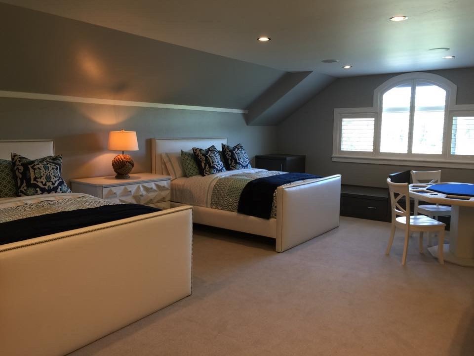 This is an example of a large beach style loft-style bedroom in Seattle with grey walls, carpet and no fireplace.