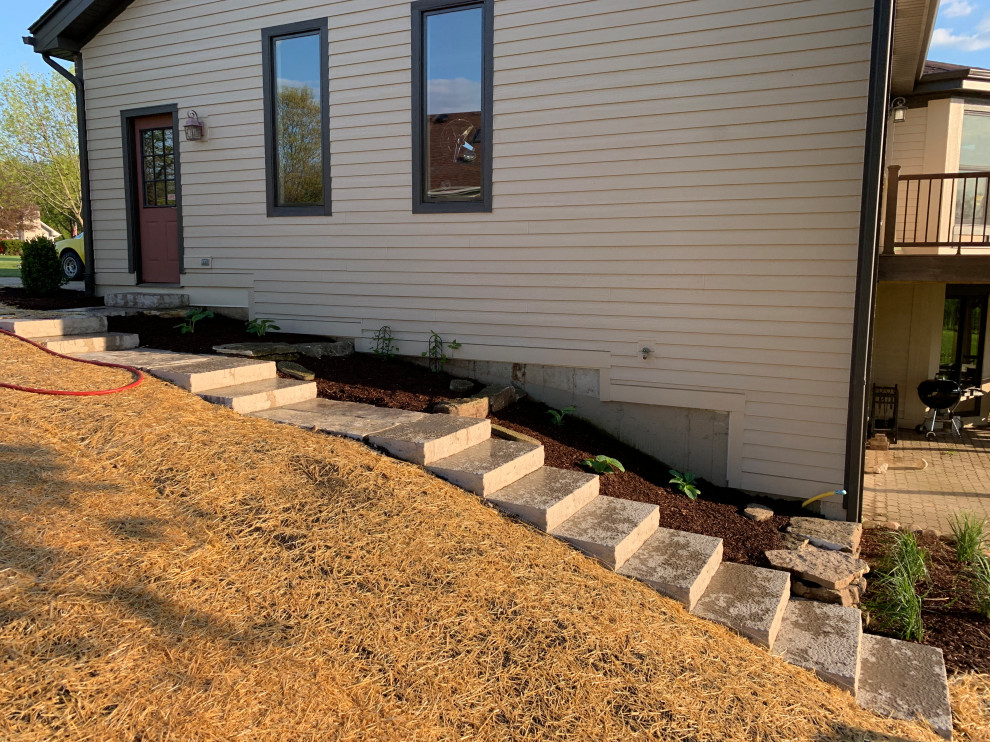 Design ideas for a mid-sized traditional partial sun hillside stone walkway in Chicago for summer.