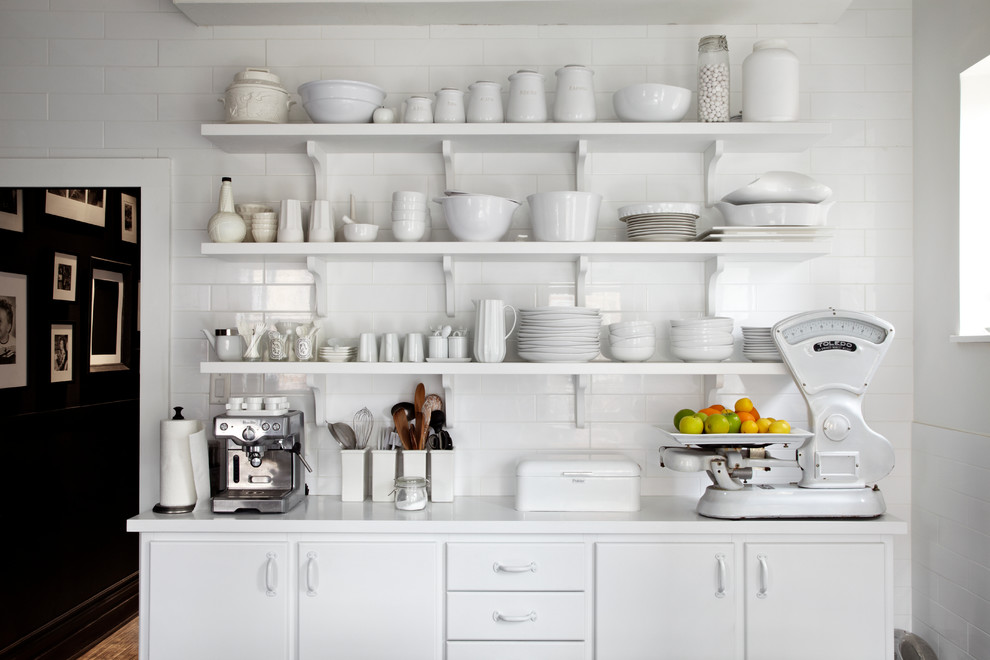 Contemporary kitchen in Toronto with flat-panel cabinets, white cabinets, white splashback and subway tile splashback.
