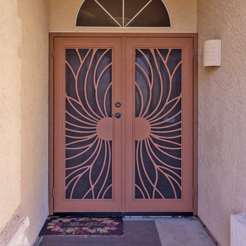 Photo of a large eclectic front door in Phoenix with beige walls, concrete floors, a double front door and a brown front door.