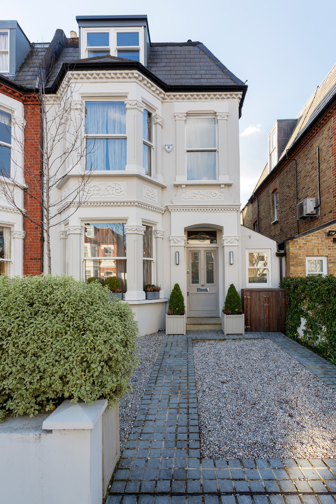 Mid-sized traditional three-storey white duplex exterior in London.