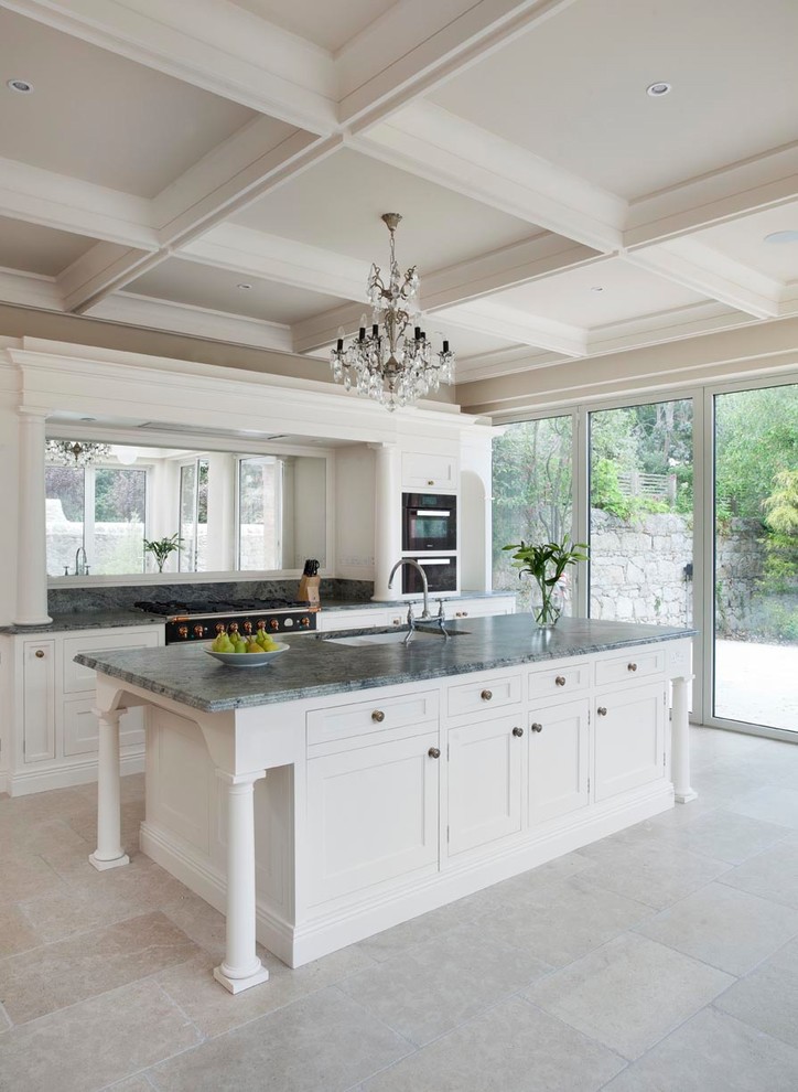 Large traditional single-wall eat-in kitchen in Dublin with a drop-in sink, shaker cabinets, white cabinets, quartzite benchtops, mirror splashback, black appliances, ceramic floors, with island, grey floor and green benchtop.