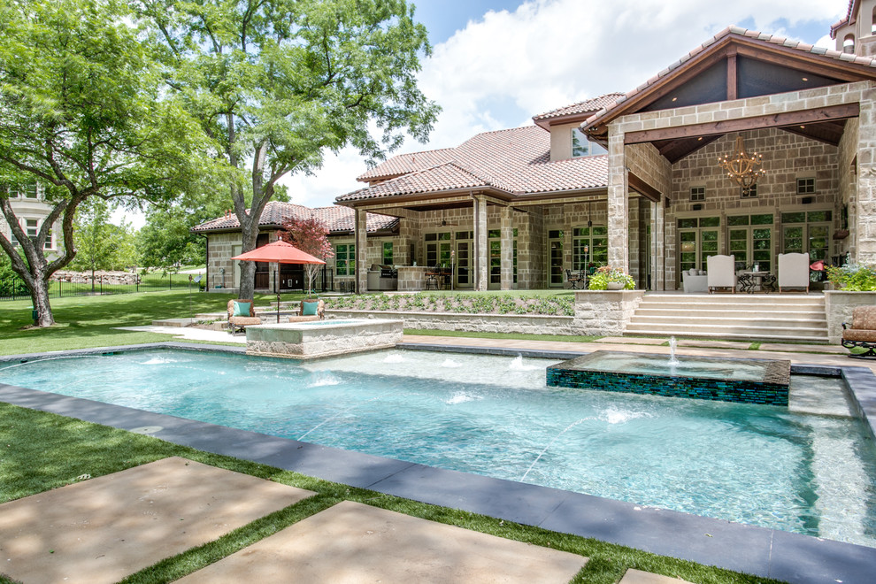 Traditional backyard rectangular pool in Dallas with a hot tub.