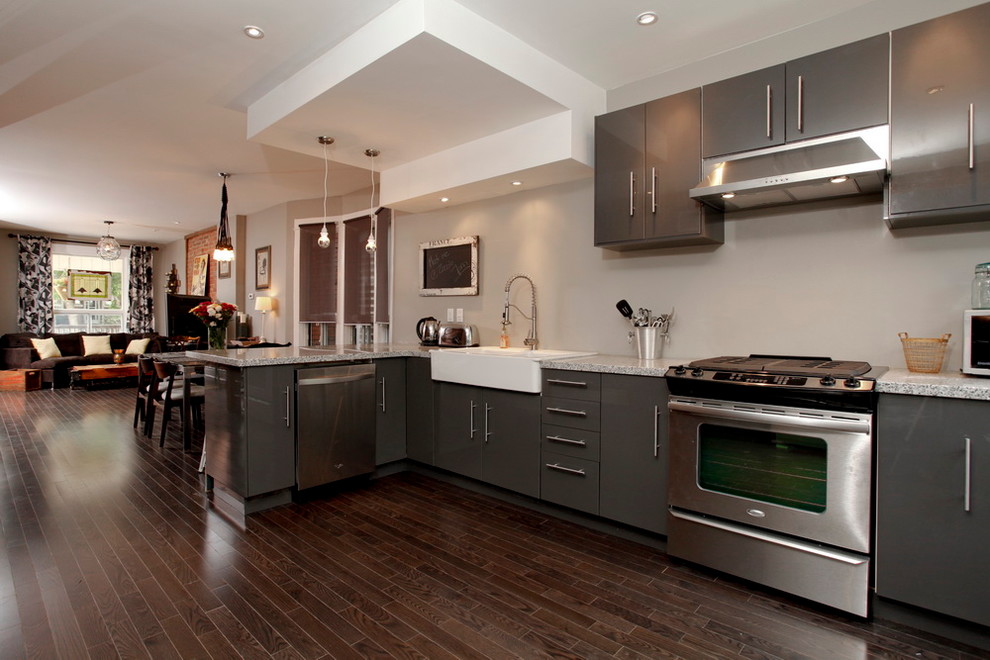 This is an example of a contemporary kitchen in Toronto with flat-panel cabinets, grey cabinets and a farmhouse sink.