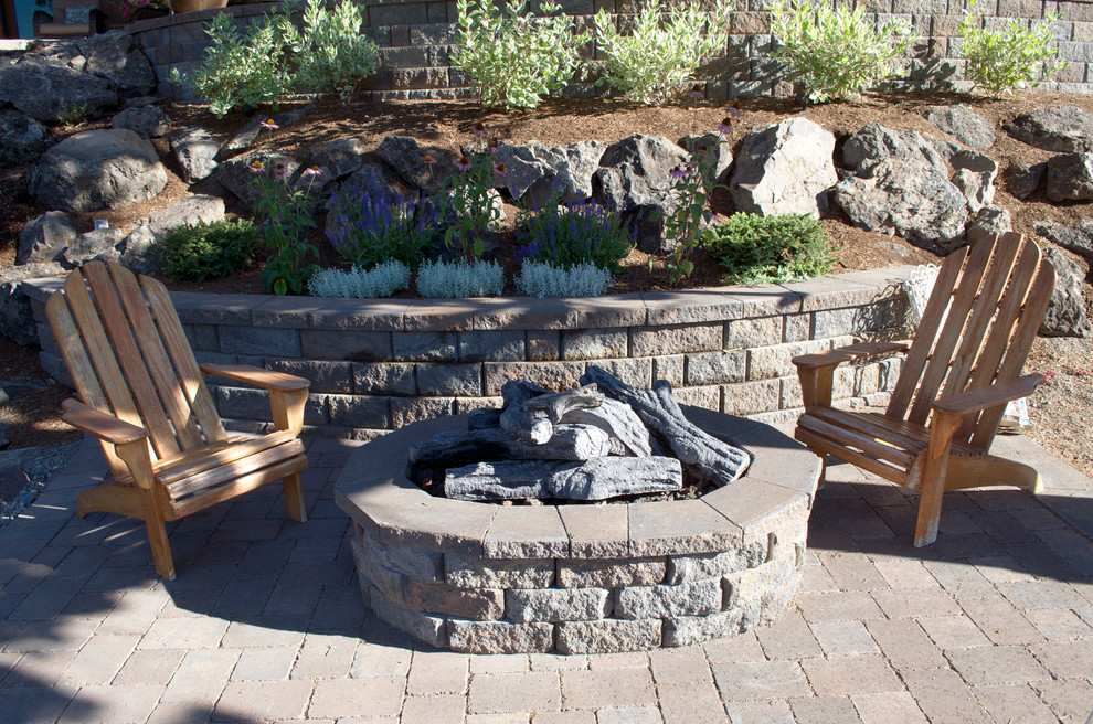Country backyard garden in Other with a fire feature and concrete pavers.