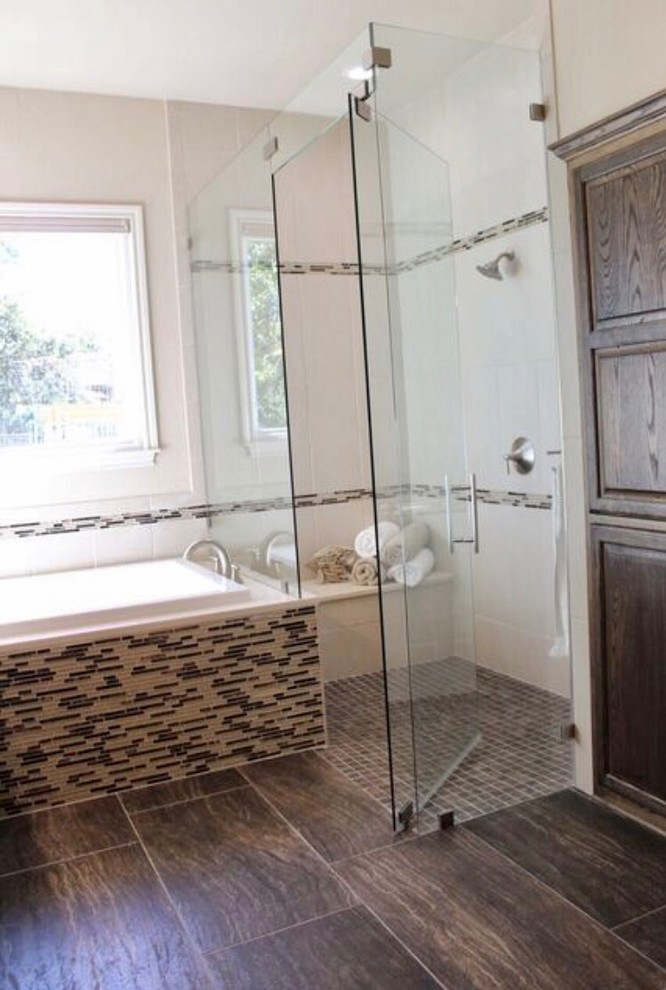 Drop-in bathtub - large transitional master beige tile and porcelain tile porcelain tile and brown floor drop-in bathtub idea in Austin with raised-panel cabinets, brown cabinets, a two-piece toilet, beige walls, an undermount sink, granite countertops, a hinged shower door and beige countertops
