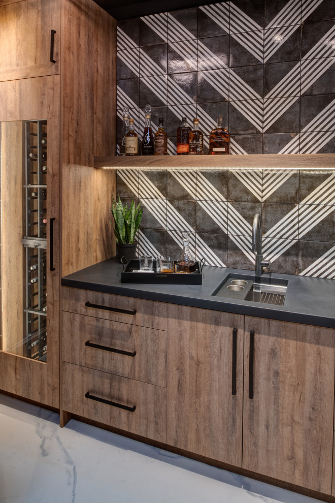 Inspiration for a mid-sized transitional single-wall wet bar in Other with an undermount sink, flat-panel cabinets, light wood cabinets, concrete benchtops, black splashback, porcelain splashback, concrete floors, white floor and black benchtop.